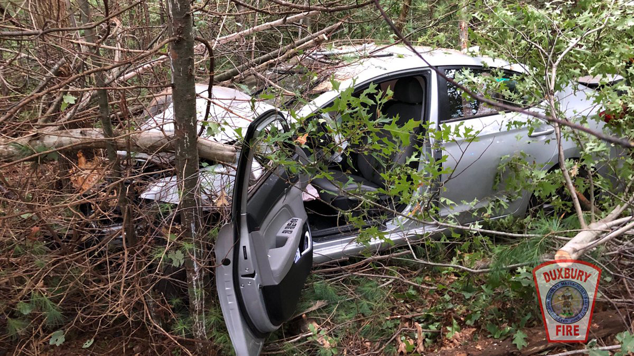Duxbury firefighters cut through car crashed into the woods to rescue